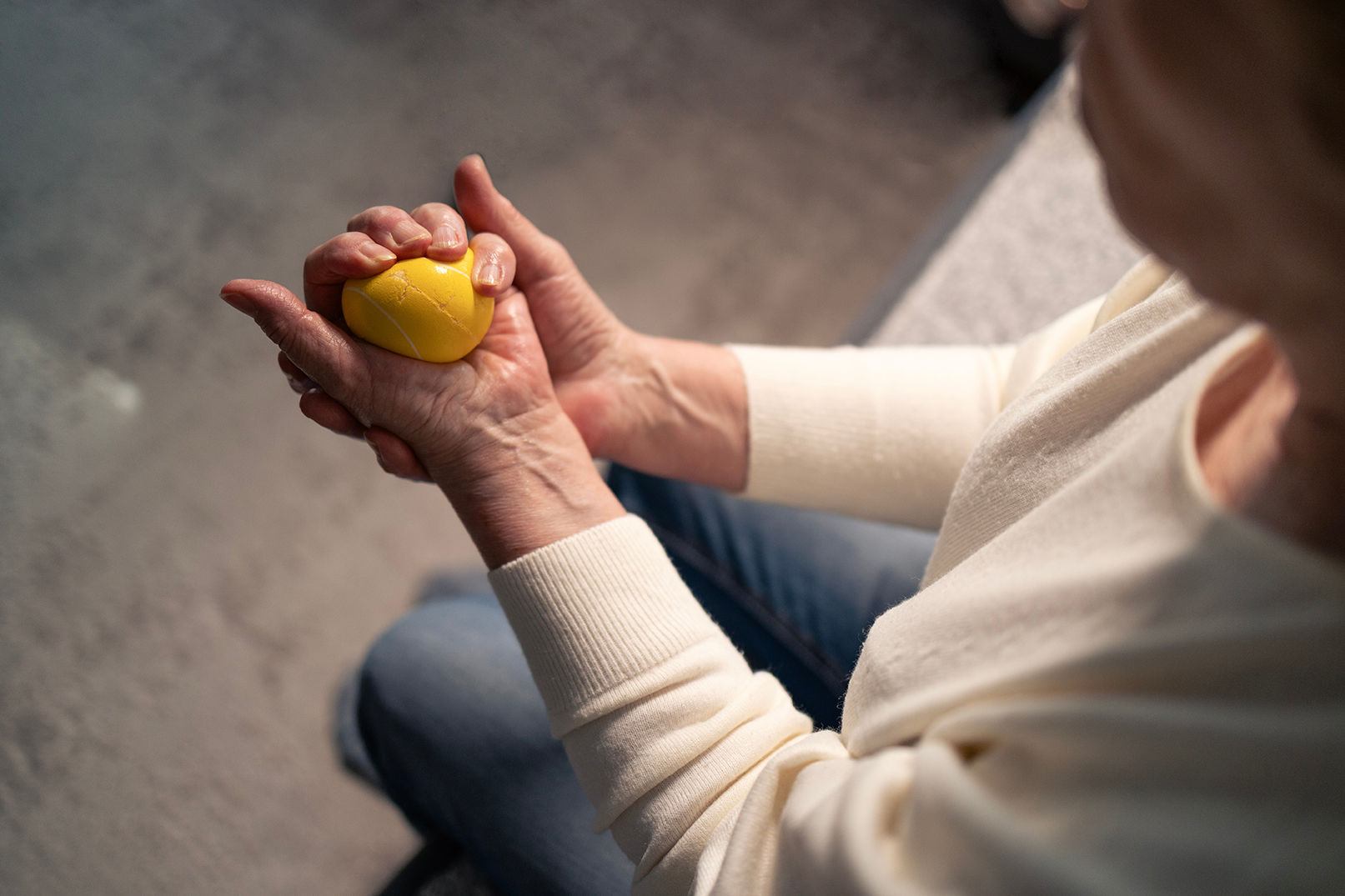 A person's hand squeezing stress ball improving rheumatoid arthritis